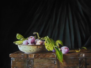 Still life with plums on a casket