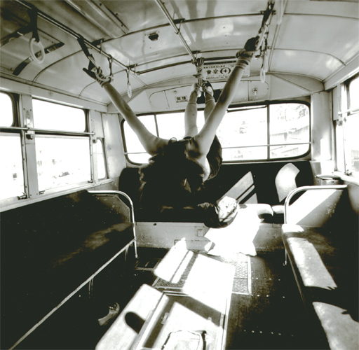 Kishin SHINOYAMA - Photography - (girl tied up hanging in bus)